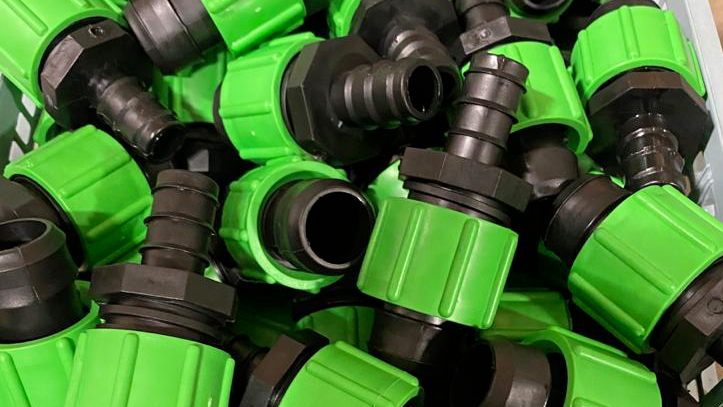 Closeup of green Greener Drip connectors showcasing detail and quality.