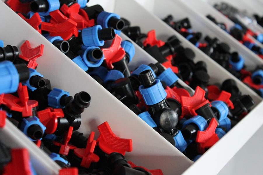 Red and blue Greener Drip connectors demonstrating product variety.